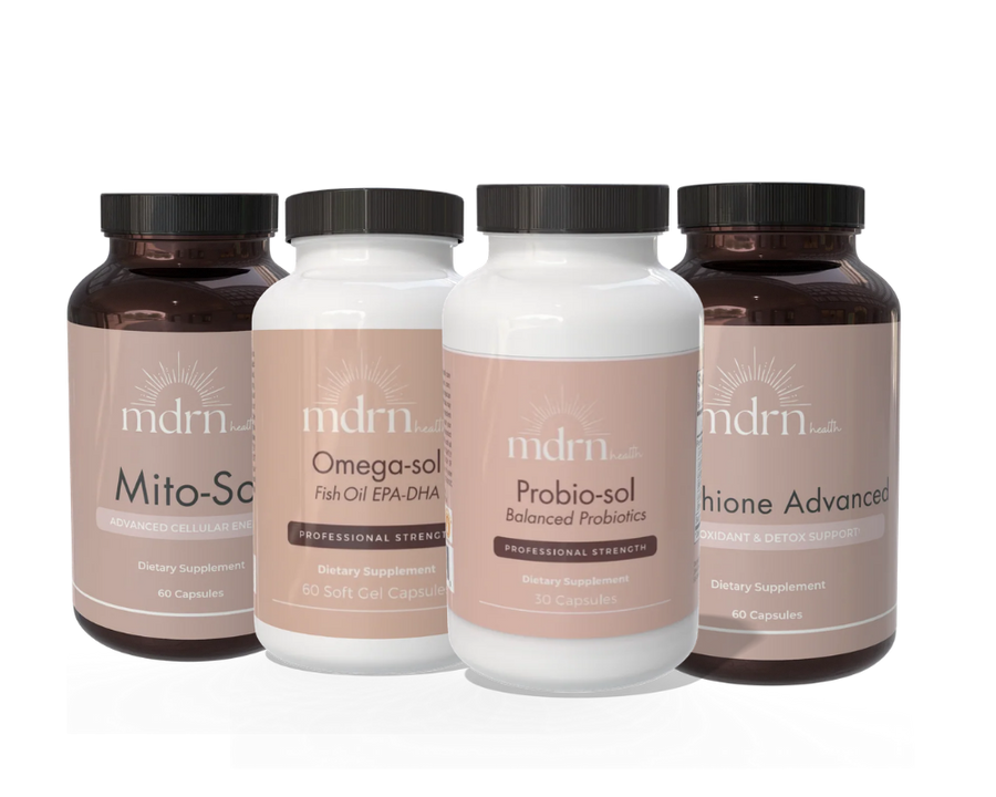 Four MDRN dietary supplement bottles arranged in a row against a white background. The bottles are dark amber brown with black caps, and the labels are a muted taupe-beige color.